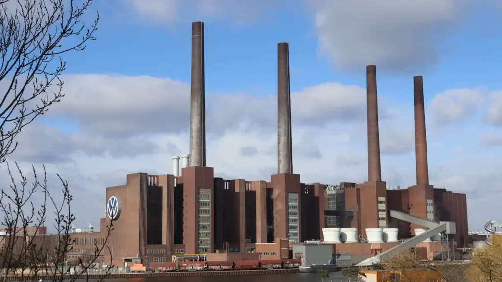 Ein großes Industriewerk mit hohen Schornsteinen an einem sonnigen Tag in Deutschland.