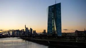 EZB-Gebäude und Frankfurter Skyline bei Sonnenuntergang über dem Mainufer